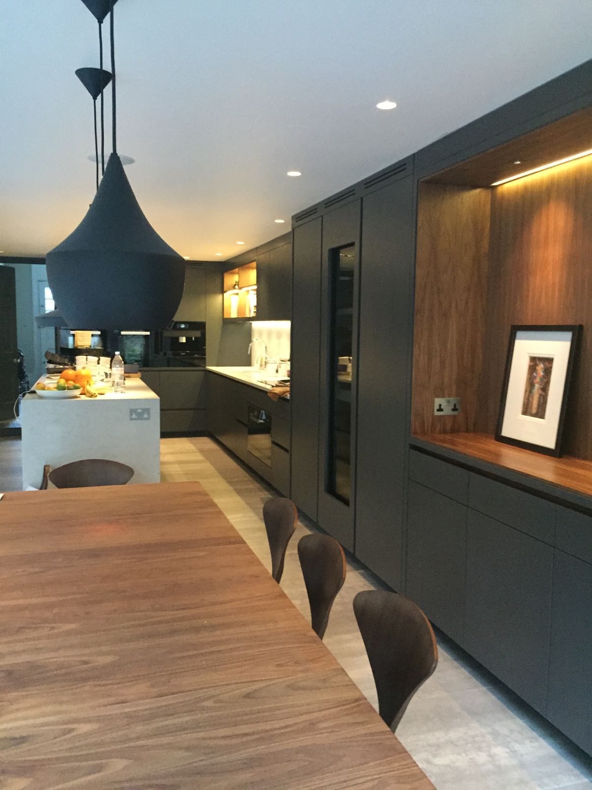 Dark blue bespoke kitchen in London with book-matched walnut veneer